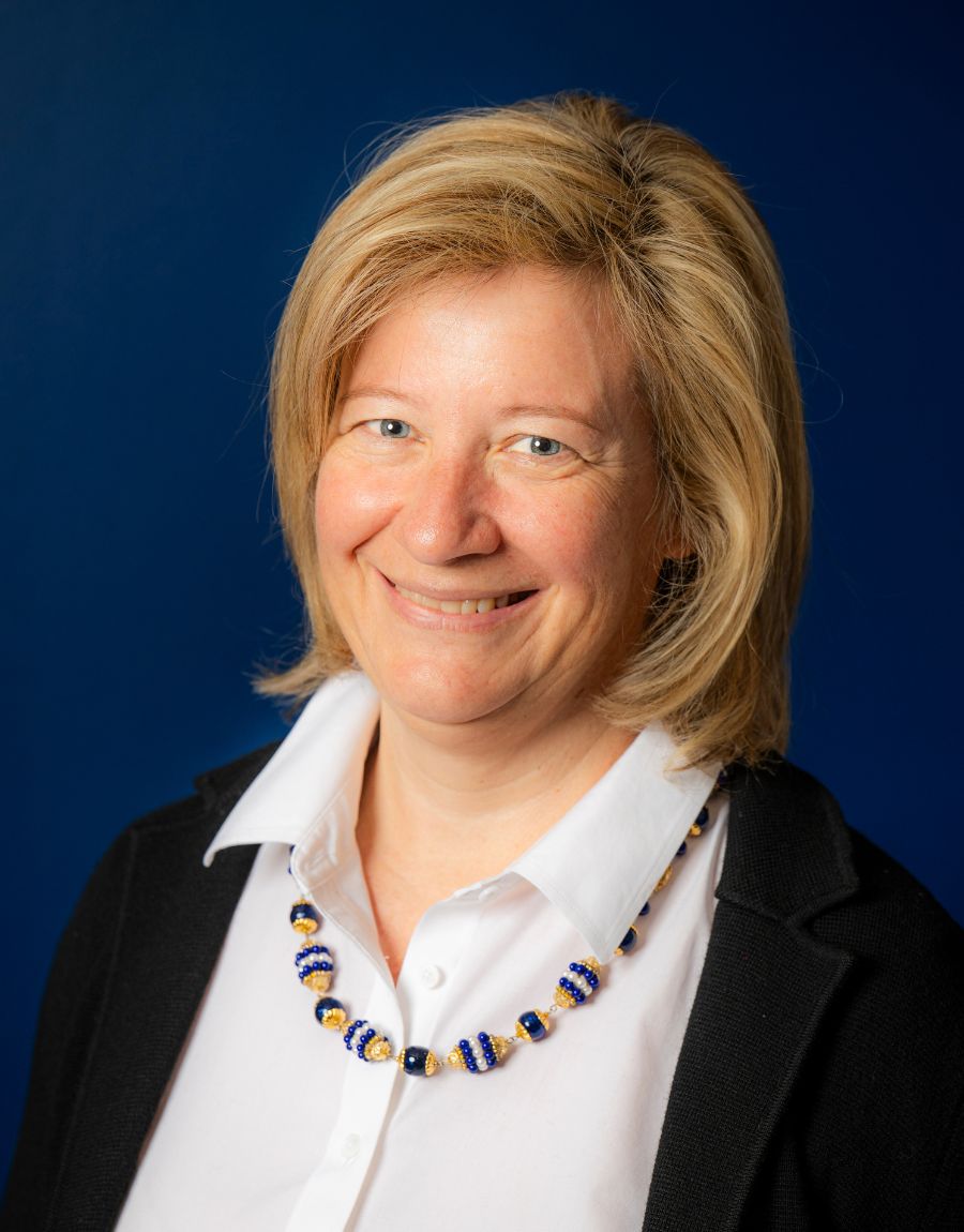 Headshot of therapist against blue background.
