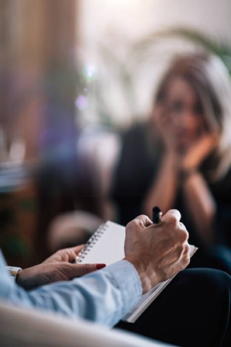 Psychological Therapy - Blurred Woman Talking to Psychotherapist in Cognitive Behavioral Therapy Session